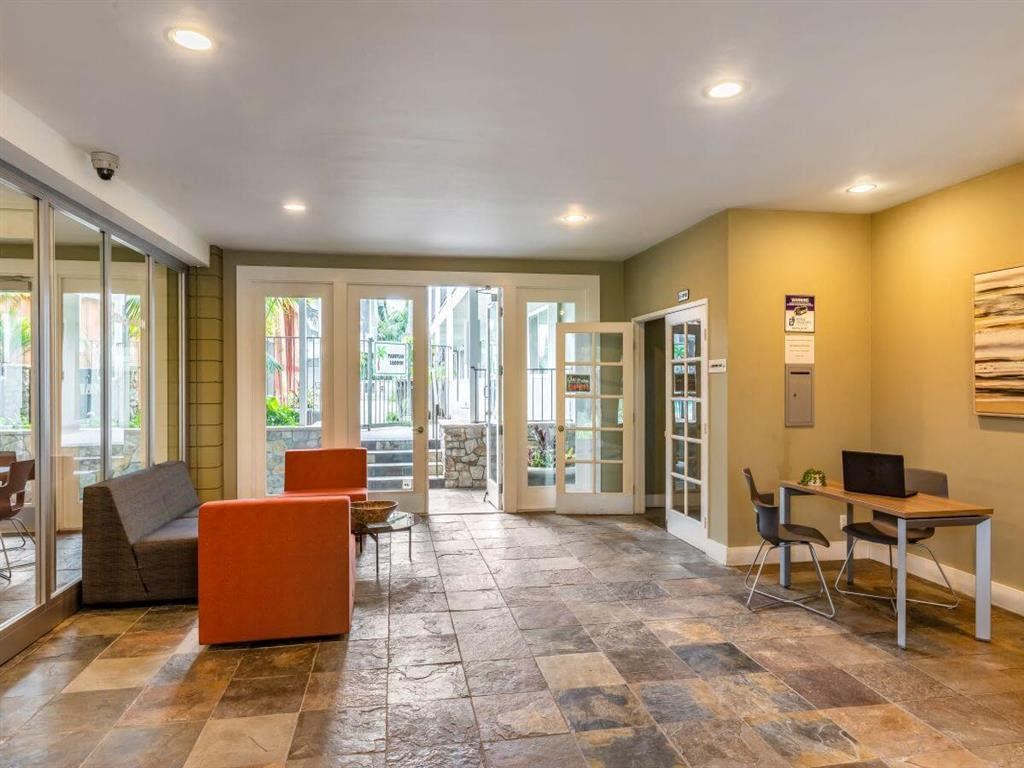 a living room with a couch and a table with chairs