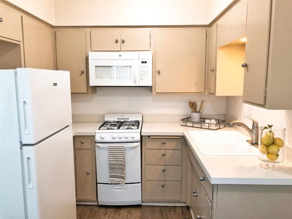 a kitchen with white appliances and white cabinets