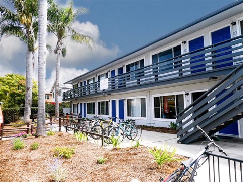 A blue and white building with bicycles parked in front.