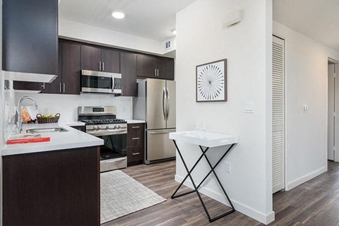a kitchen with a sink and a refrigerator