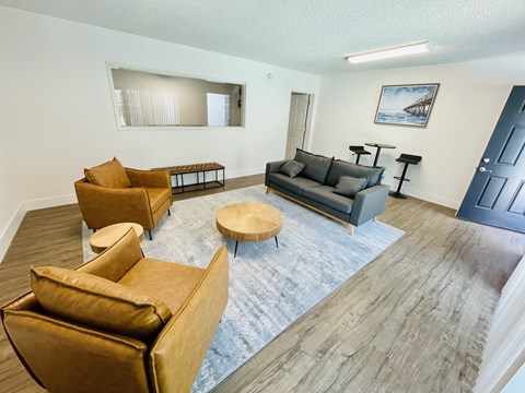 A living room with a grey couch and a brown chair.
