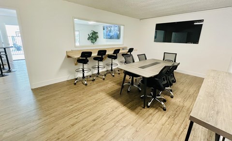 A conference room with a long table and chairs.
