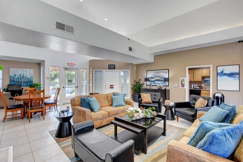 a living room with couches and chairs and a table
