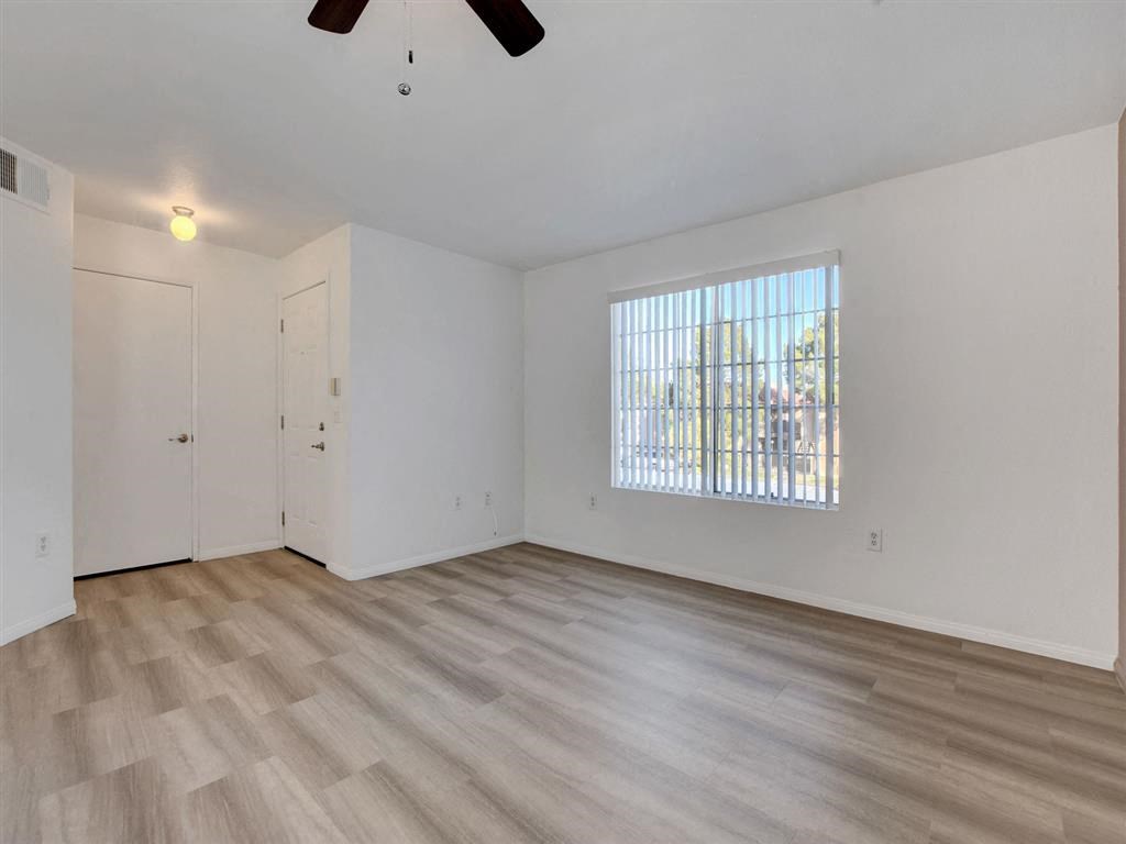 an empty living room with a large window