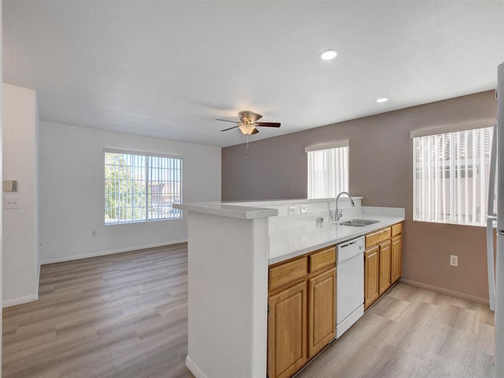 a kitchen with a counter top and a ceiling fan