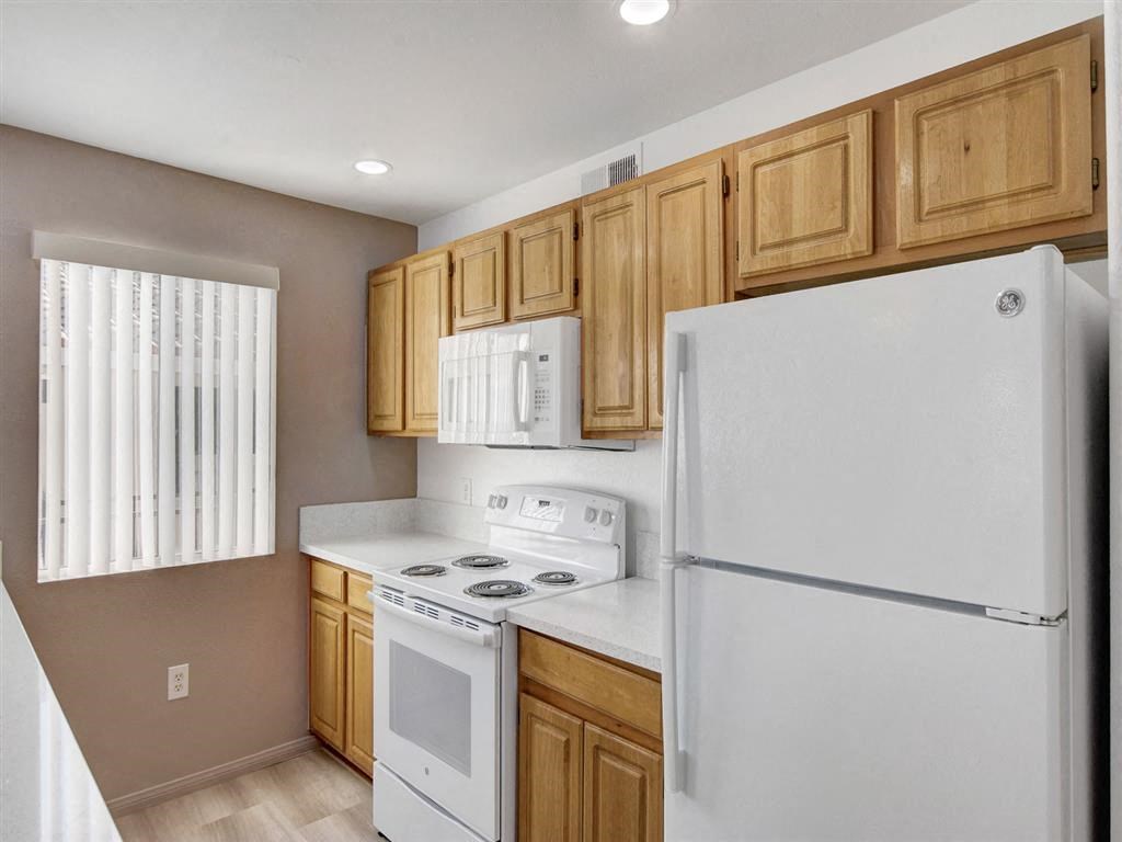 a kitchen with a refrigerator freezer and a stove top oven