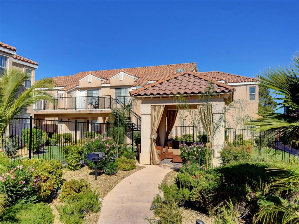 a pathway leading to a building with a tiled roof