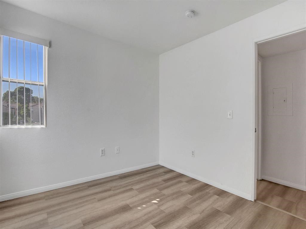 an empty room with a window and a door