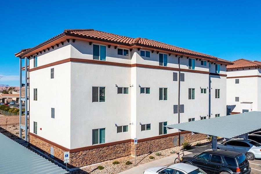 a large white building with green shutters