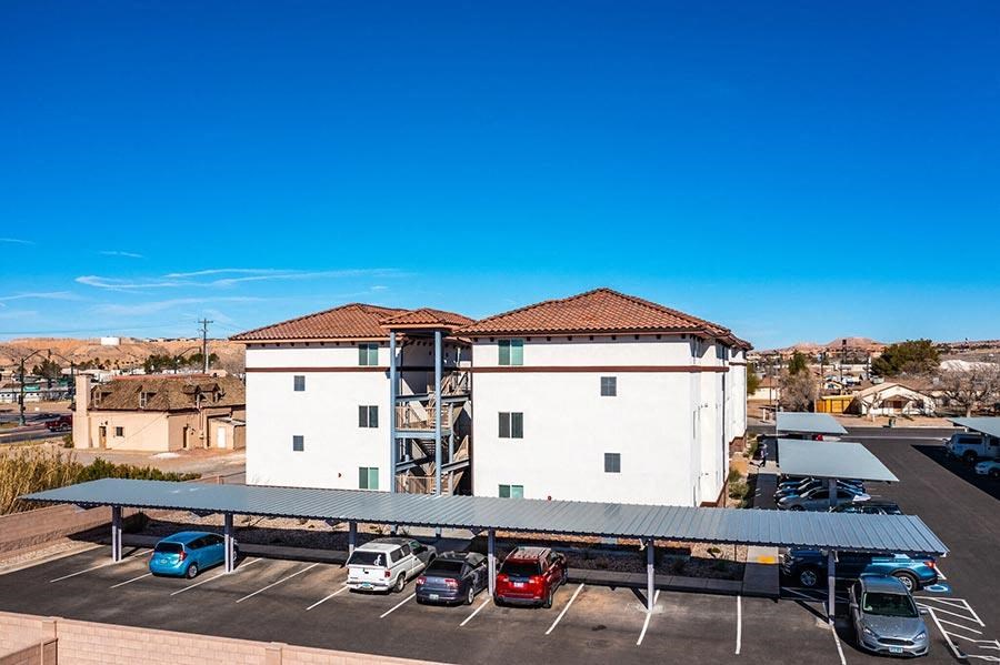 a large white building with a parking lot in front of it