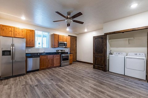 a kitchen with stainless steel appliances and a ceiling fan
