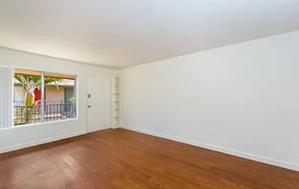 living room with wooden floors and white walls.