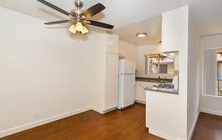 kitchen with a refrigerator, sink, and a ceiling fan.