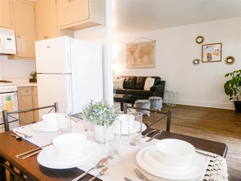 a kitchen and dining room with a table and a refrigerator