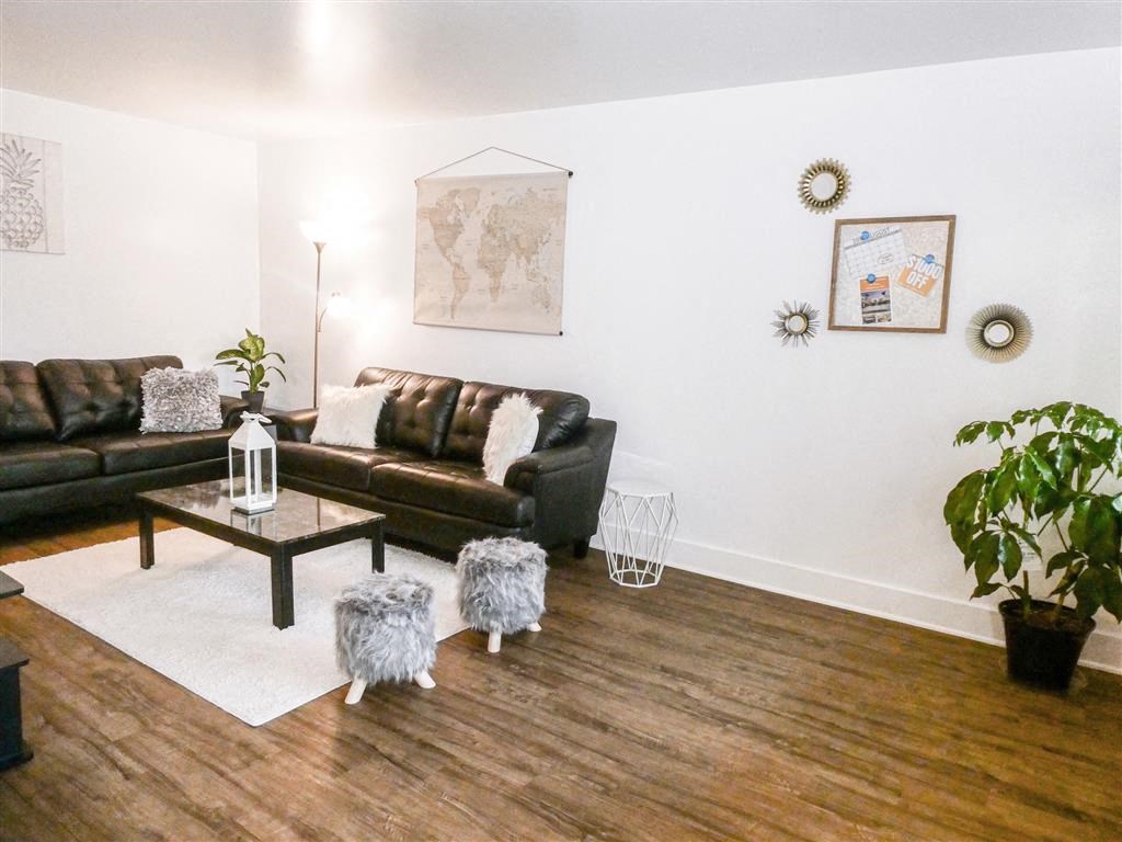 a living room with leather couches and a table