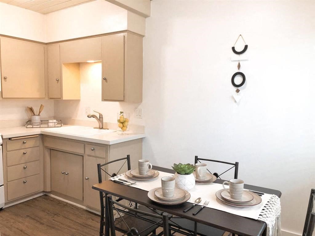 a kitchen and dining room with a table and chairs