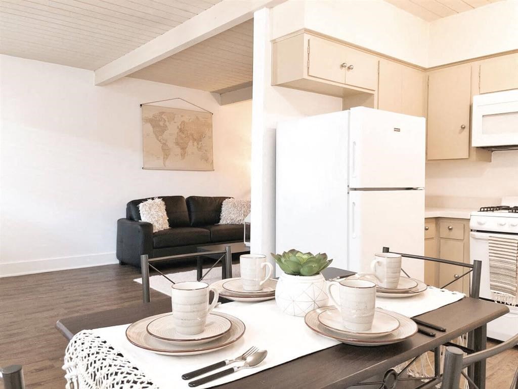 a kitchen and dining room with a table and chairs