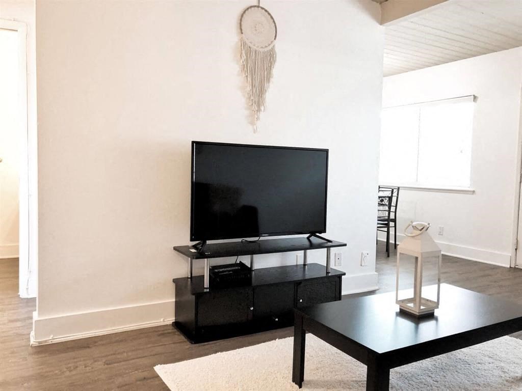 a living room with a television and a table