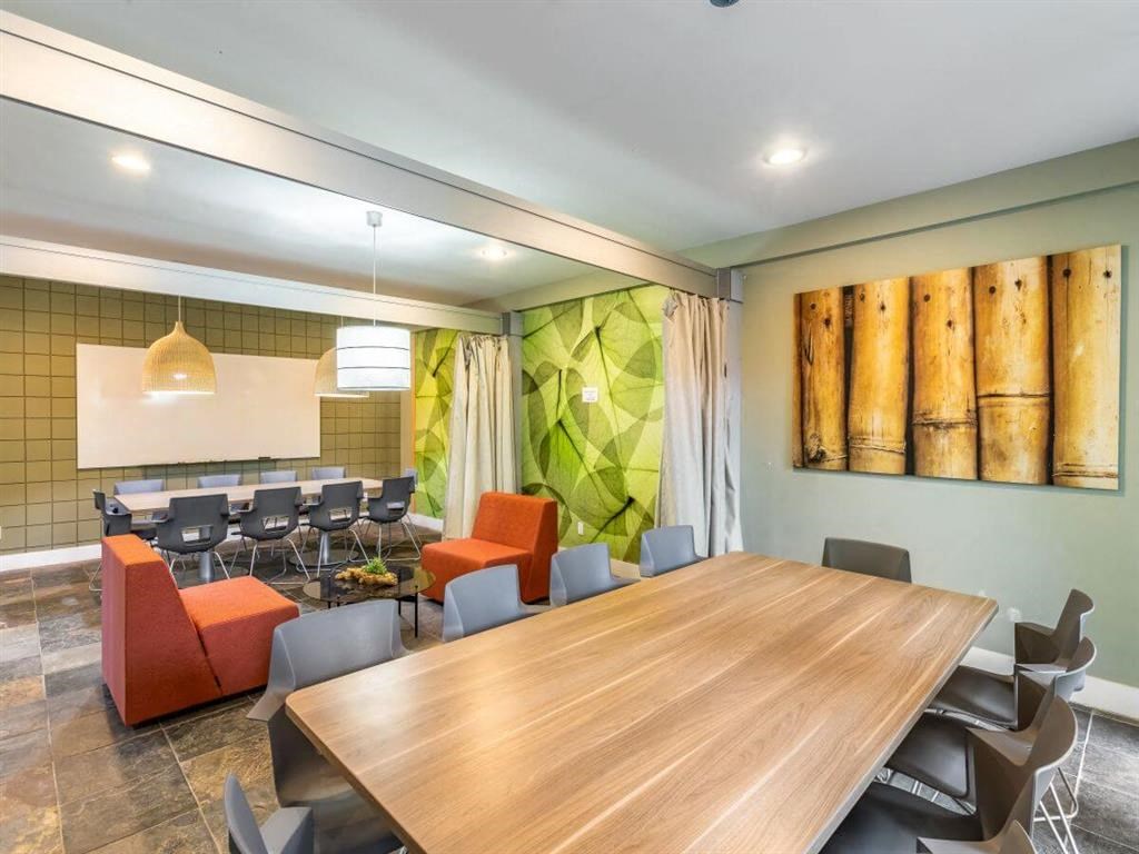 a conference room with a large wooden table and chairs