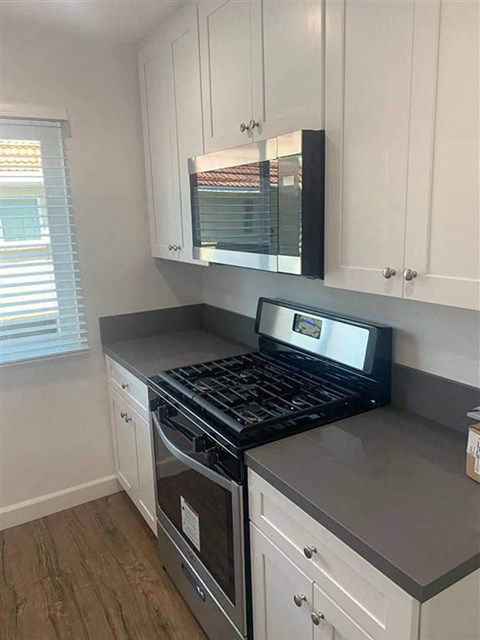 a kitchen with a stove and a microwave