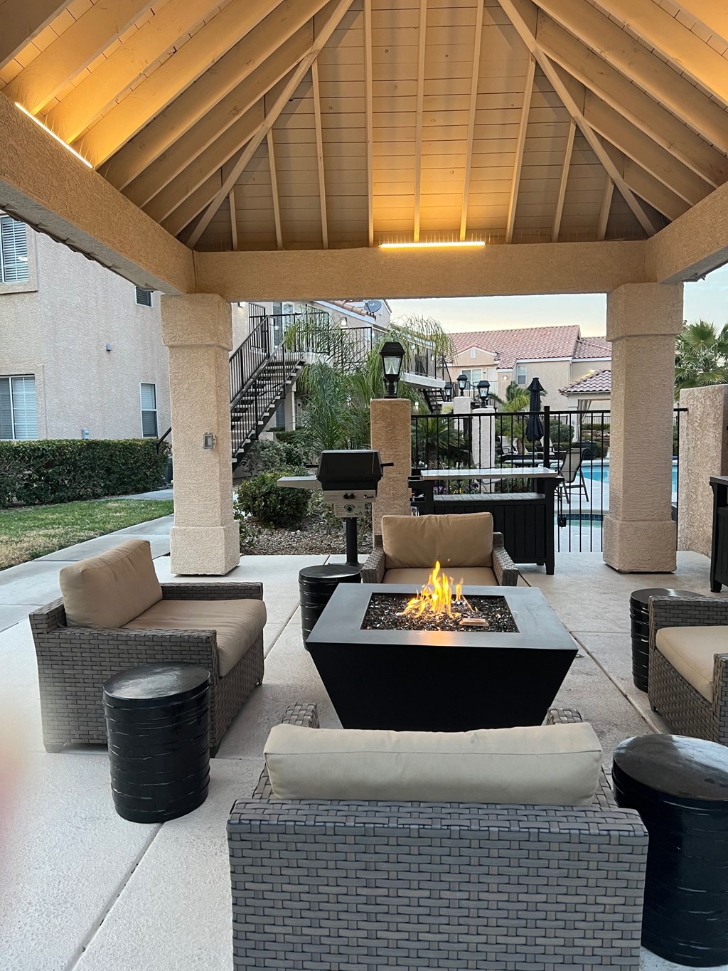 a patio with a fire pit