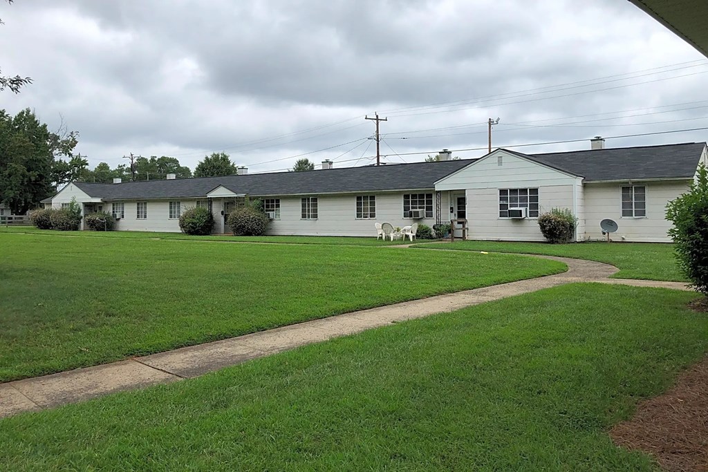 a white house with a lawn in front of it