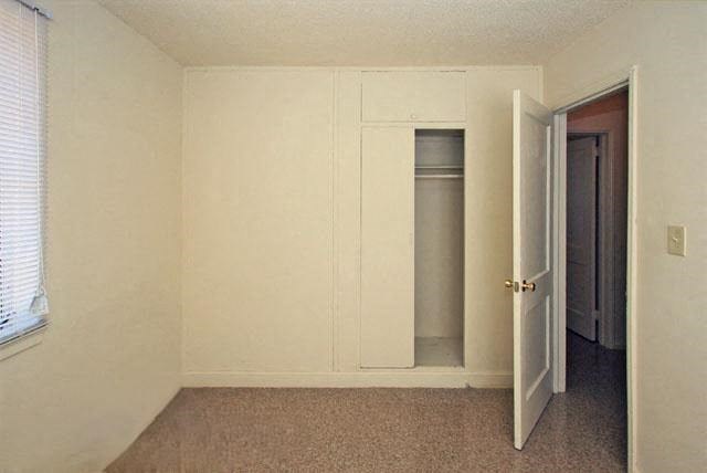 an empty room with a door and a closet