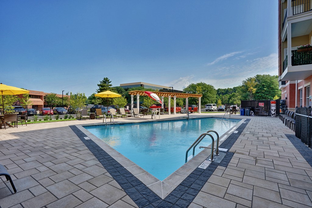 a swimming pool at a hotel with umbrellas
