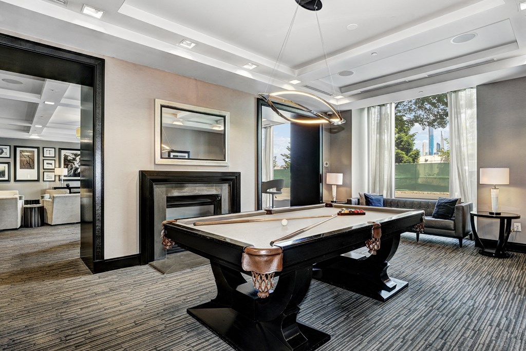 a game room with a pool table and a fireplace