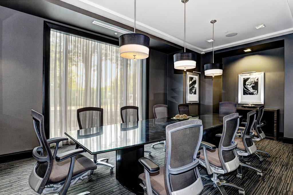 a conference room with a glass table and chairs