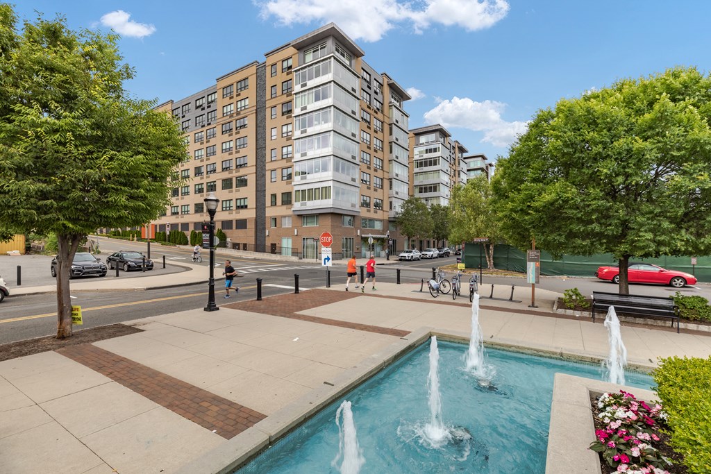 a city street with a fountain and a swimming pool