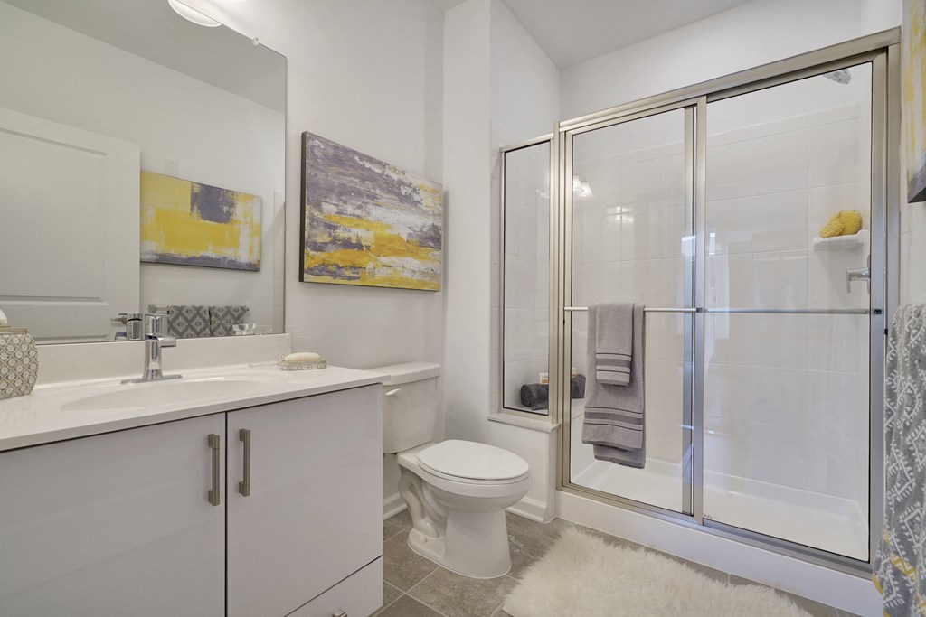 a bathroom with a shower and a sink and a toilet