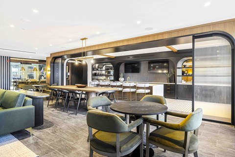 A modern dining area with a long table and chairs.
