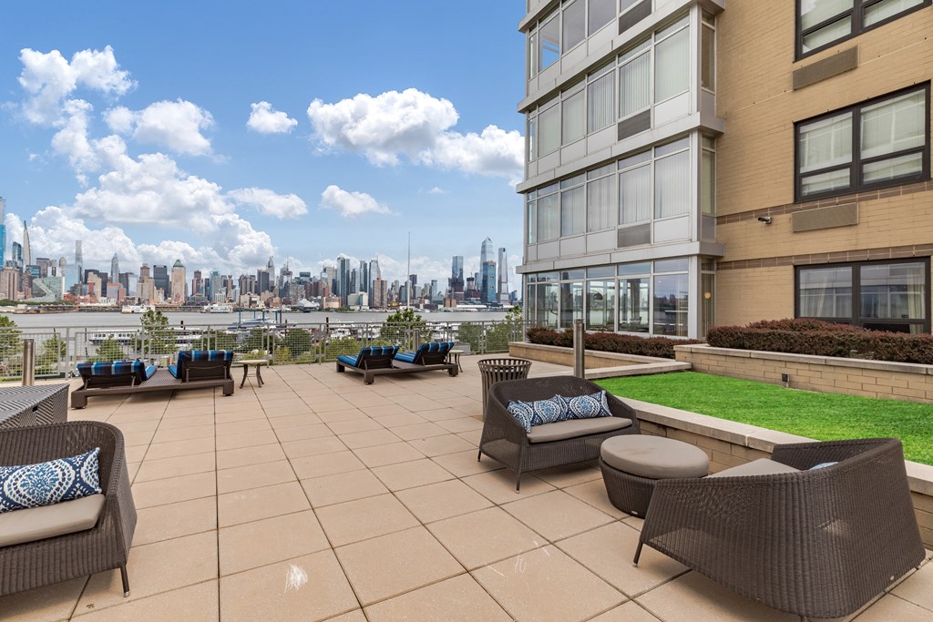 a large patio with chairs and a view of the city