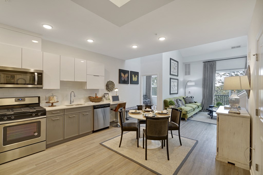 a kitchen and living room with a table and chairs