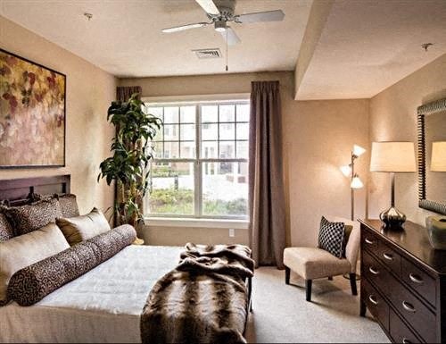 a bedroom with a large bed and a window