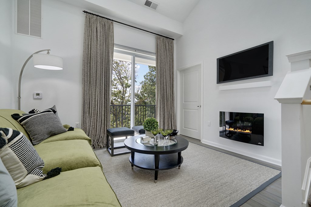 a living room with a couch and a coffee table and a fireplace