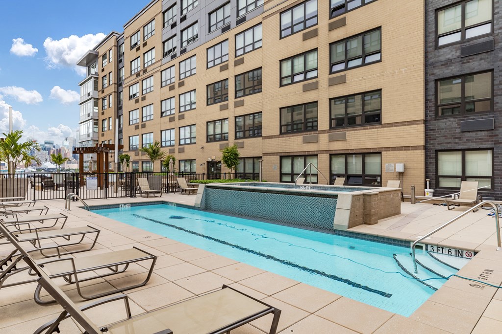 our apartments have a pool and lounge chairs in front of our building