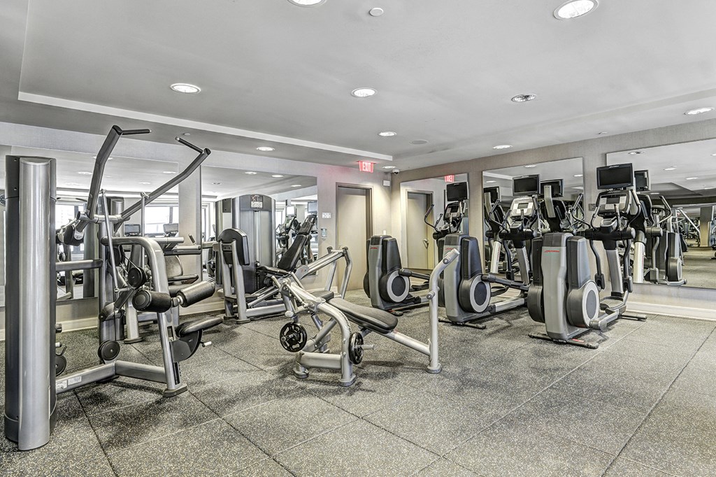 a gym filled with cardio equipment in a building