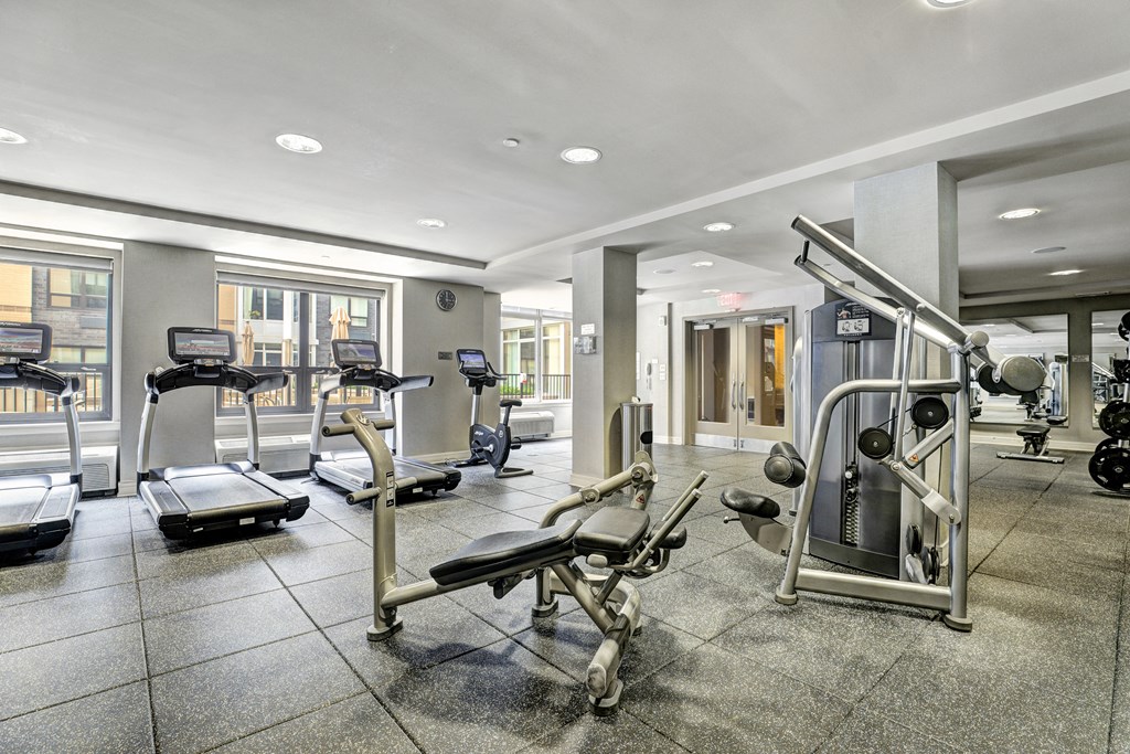 a gym with weights and other exercise equipment in a building