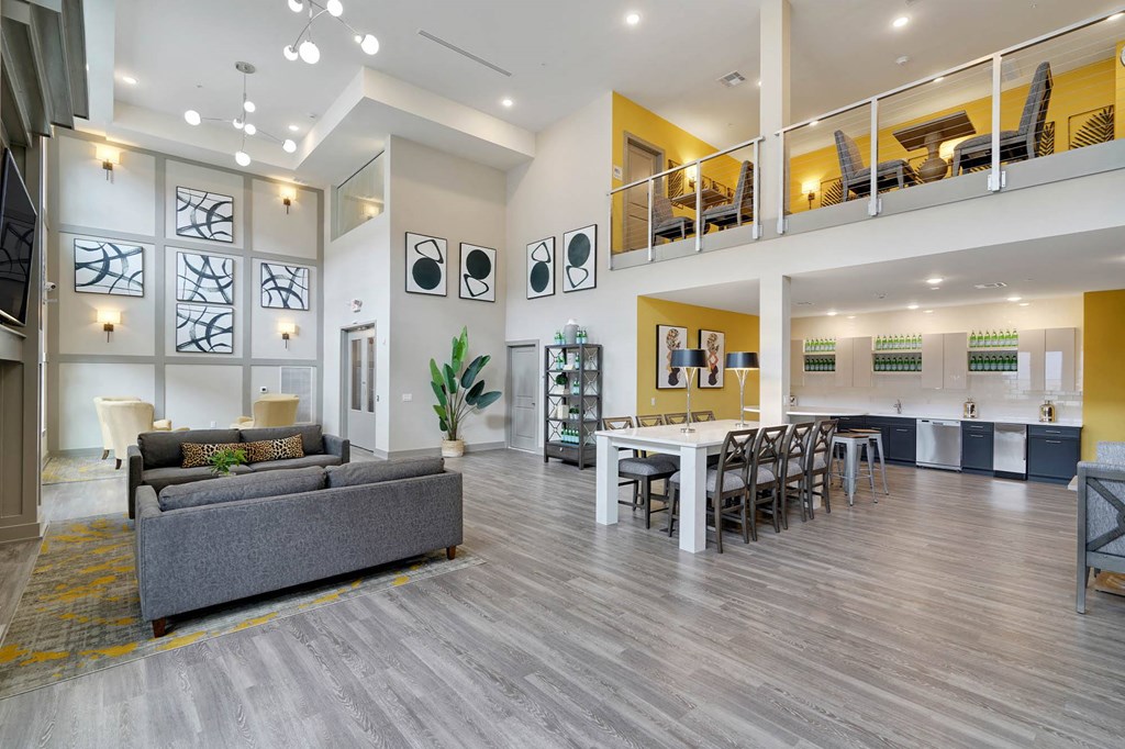 a living room and dining room with a table and chairs