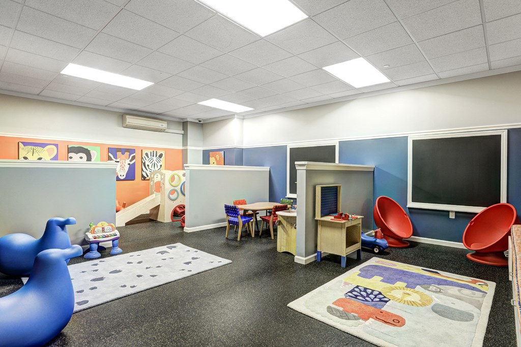 a childrens play room with toys and a tv