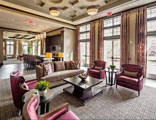 a living room with couches and chairs and a table