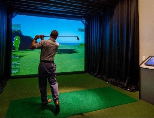 a man playing a game of golf on a simulator