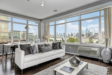 a living room with a white couch and a view of the city