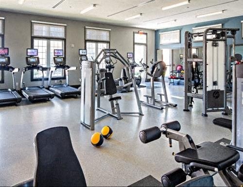 a gym with a lot of exercise equipment in it
