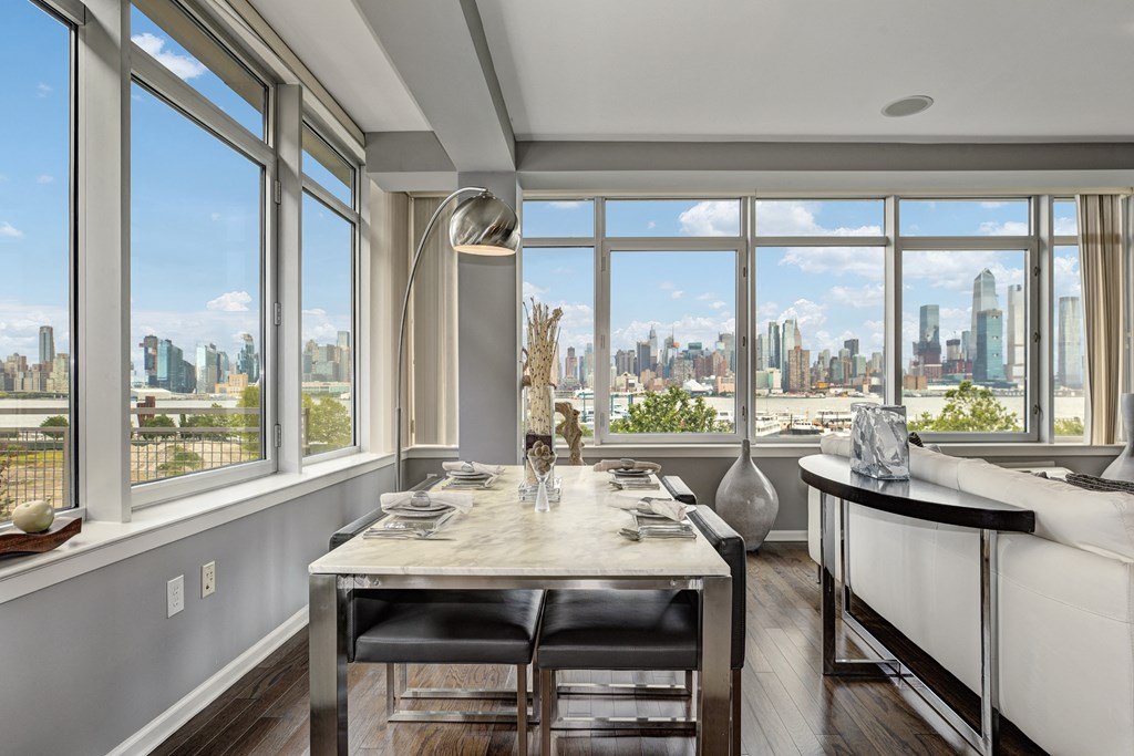 a dining room with a table and a view of the city