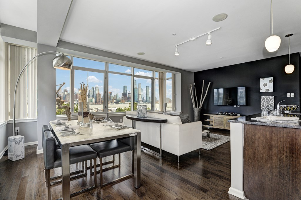 a dining room with a table and chairs and a large window