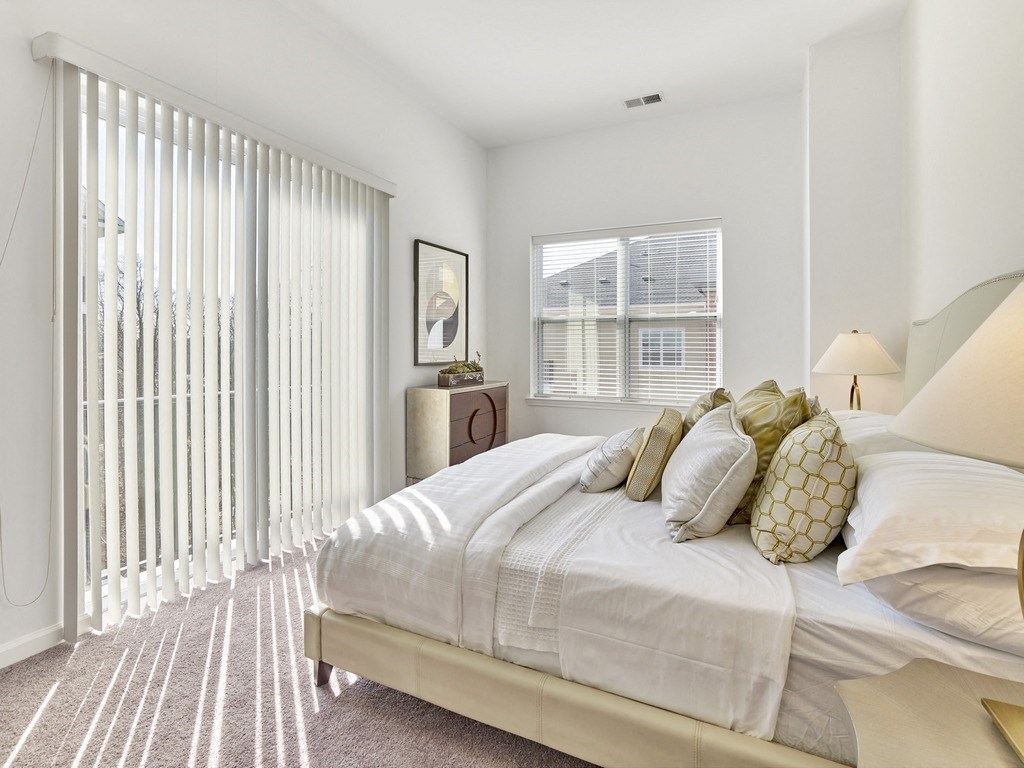 a bedroom with a large bed and a large window