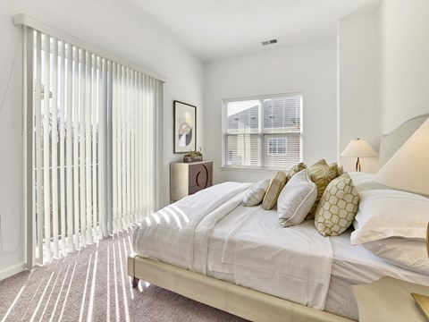 a bedroom with a large bed and a large window